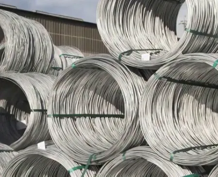 Industrial workers inspecting steel materials during manufacturing operations